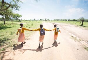 Image of little girls walking together, holding hands