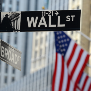 Stock image of American flag and Wall St. New York