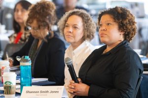 Image of women speaking at conference for Business for Impact
