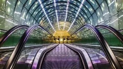 escalator going down into a metro hall