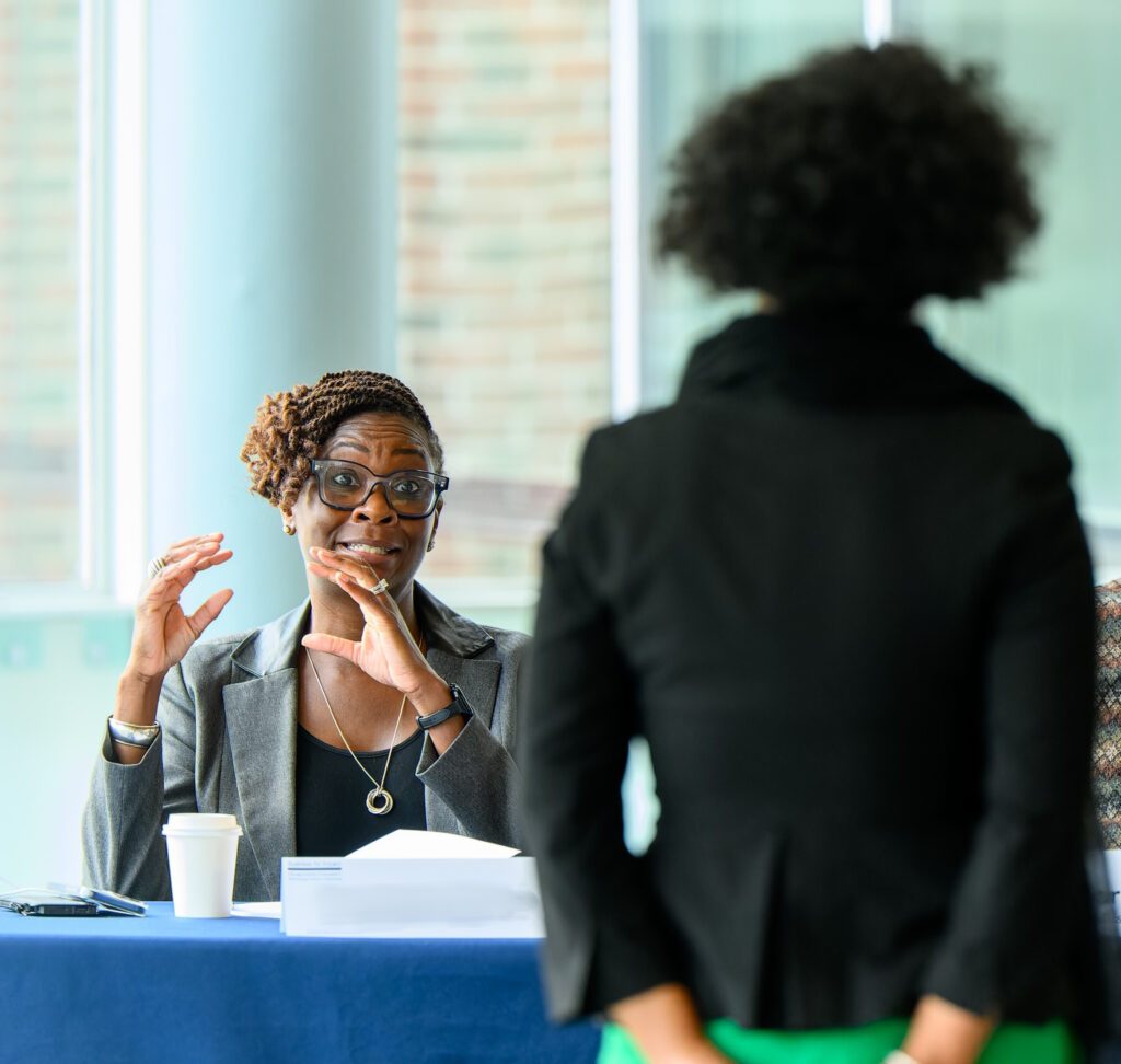 two women discuss a plan